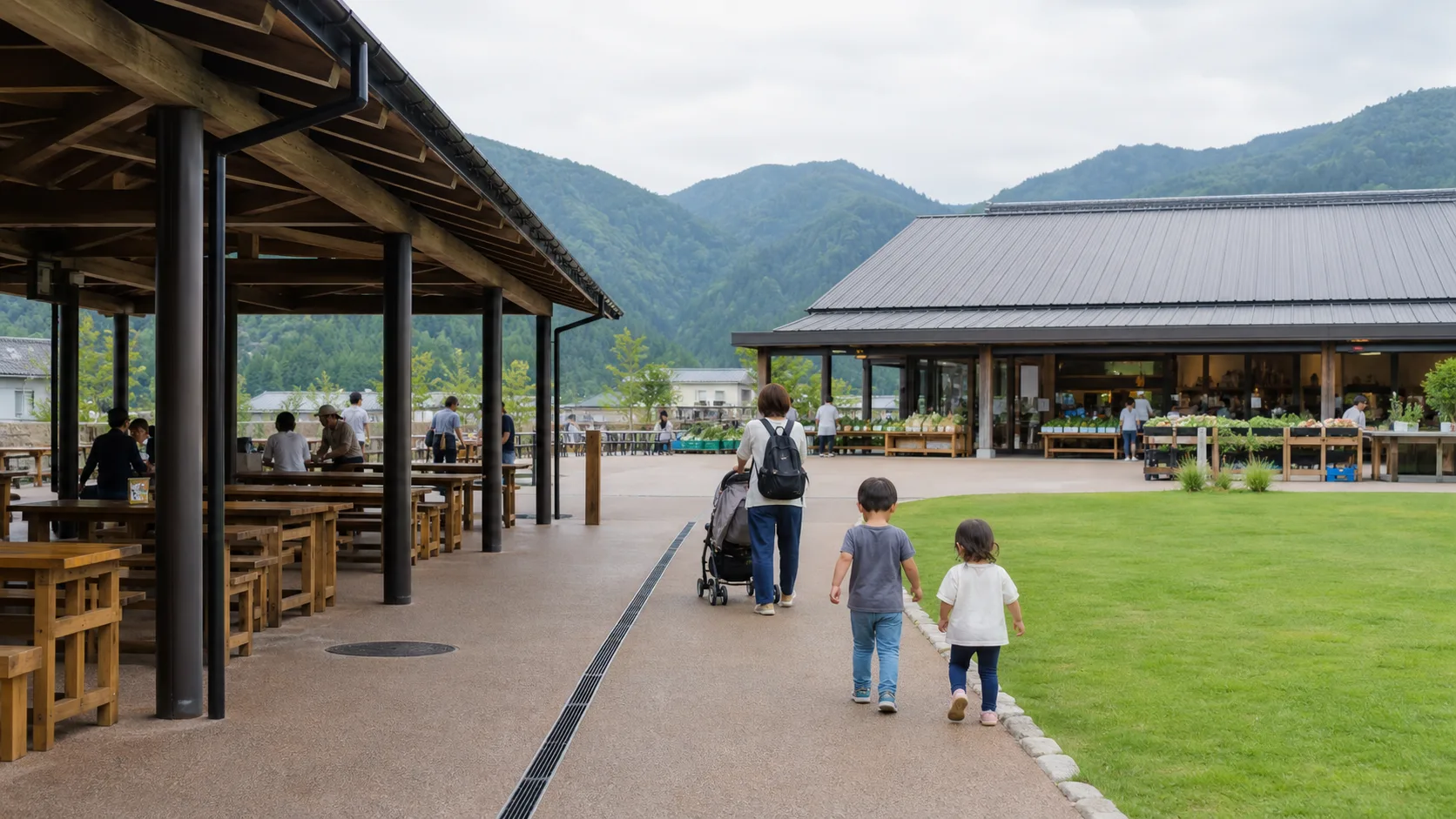 屋根付きの休憩席と芝生沿いを家族で歩く道の駅のイメージ写真